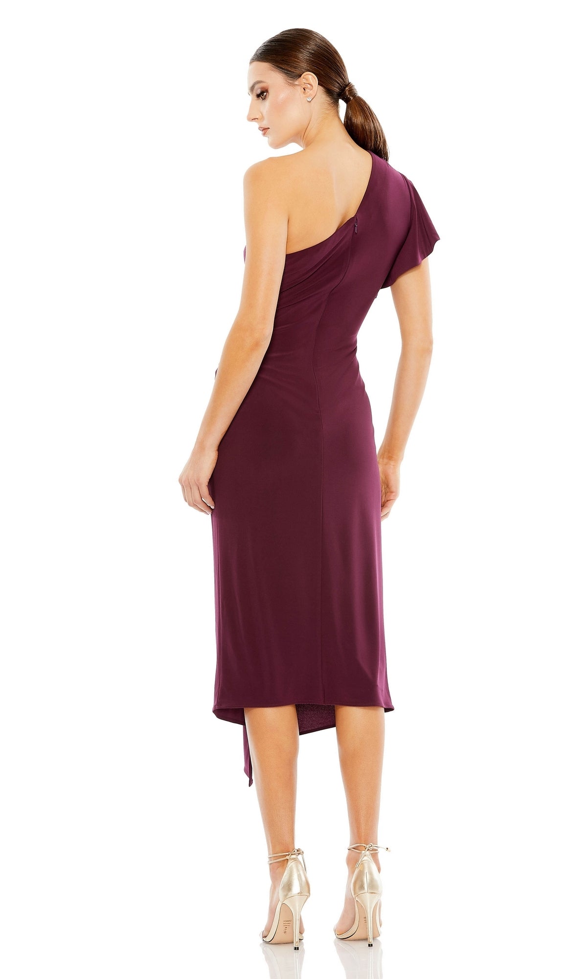 A woman stands facing away, wearing the One-Shoulder Knot-Waist Midi Party Dress 12480 by Mac Duggal in burgundy and metallic high heels against a white background.